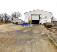 An industrial building suitable for business, outdoor area with blue containers.