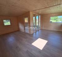 The interior of a wooden cottage with light wood, large windows, in Gardens for relaxation.