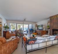 Living room in a family house with a fireplace and comfortable seating, floor with wooden decor.