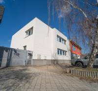 A family house on Bratislavská Street in Pezinok with a paved yard and a silver car.