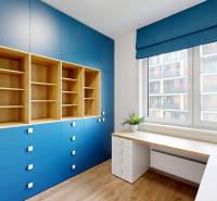 A study room in a 4-room apartment with blue cabinets and a wood-patterned floor.