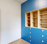 Built-in blue wardrobe with wood decor in a 4-room apartment.