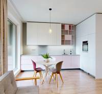 A kitchen with a dining table and a wooden decor floor in a 4-room apartment.