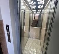 An elevator with a wooden decor floor in a 3-room apartment.
