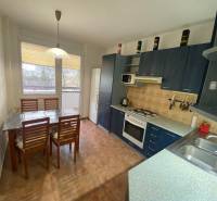 Kitchen in a 3-room apartment with a dining table and kitchen unit.
