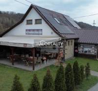Gastro premises in Hnúšťa with a terrace, solar panels, and a stone exterior.