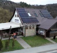 A restaurant in Hnúšťa with outdoor seating and solar panels offers dining spaces.