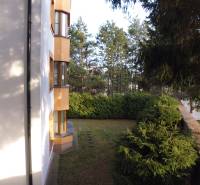 The exterior of the building on Vesela Street in Prešov, showing greenery and trees.