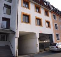 The exterior of the building on Veselá Street in Prešov includes a parking lot and an entrance.