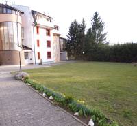 Exterior at an apartment building with a lawn and flowers on Veselá Street in Prešov.