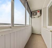 Glazed balcony in a 3-room apartment with air conditioning and a view.