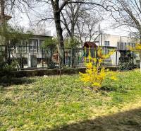 A yard with a lawn and a fence in the area of Bratislava - Nové Mesto, Šuňavcová, 3-room apartment.