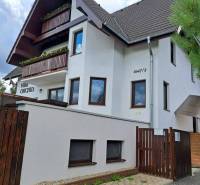 A villa with wooden balconies and a brown roof in Veľká Lomnica.