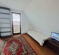 A room in a 3-room apartment with a wooden decor floor and a balcony.