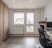 A study room in a 4-room apartment with a wooden decor floor and a large window.
