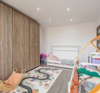 Children's room with beds, wooden decor flooring, and a large wardrobe in a 4-room apartment.