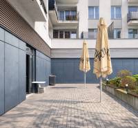 Terrace of commercial premises in Bratislava - Ružinov on Hrachova Street with paving and umbrellas.