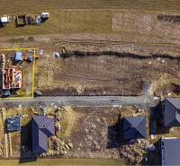 Aerial view of a construction site with a family house under construction in Tvarožná.