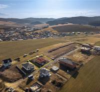 A view of the under-construction family houses in Tvarožná, surrounded by picturesque countryside.