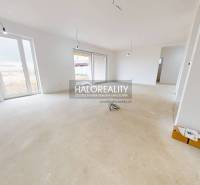 The interior of a family house with large windows, ready for completion.