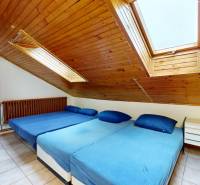 Attic room with a flat roof, double bed, and skylight in a 3-room apartment.