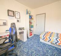 Children's room with a bed, desk, and shelf in a 3-room apartment.