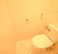 Bathroom with toilet and tiles in a 3-room apartment.