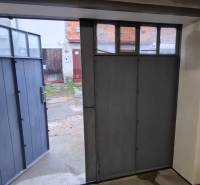 Open garage door with a view of the yard, Zvolen, Prachatická.