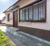 A family house in Horná Potôň with a glass veranda and a front garden.