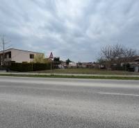 Plots - housing on Hlavná Street in Mojzesovo with gardens and a building nearby.