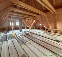 An attic of a family house with wooden decorative elements and beams.
