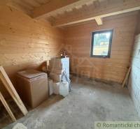 The interior of a family house with wooden paneling and building materials in the room.