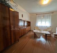 Living room in a family house with furniture and flooring with a wooden decor.