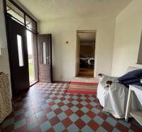 Entrance hall with tiled floor and furnishings in a family house.