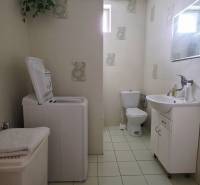 Bathroom in a family house with a washing machine and a sink.