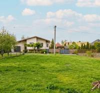 A family house in Trstín with a green lawn and fruit trees on a spacious plot.