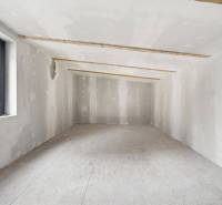 Attic space in a family house with a view of the roof through the window.