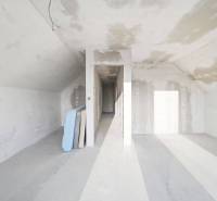 Interior of a family house with unfinished walls, illuminated by natural light.