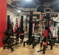 Commercial premises with exercise machines and a wooden decor floor.