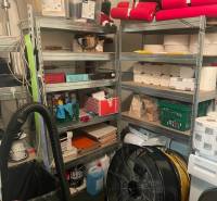 Warehouse in commercial premises with shelves full of various supplies.