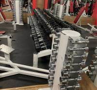 Dumbbells and fitness equipment on a glossy wooden-decor floor in commercial premises.