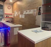 Interior of commercial premises with a counter and flooring with wood decor.
