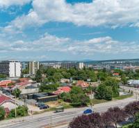 View from Pražská Street in Košice, Západ district, towards greenery and buildings.