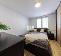 Bedroom with a double bed, wardrobes, chest of drawers, wooden decor flooring, 3-room apartment.