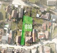 Aerial view of a plot in Marianka suitable for living, surrounded by buildings.