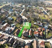 Aerial view of residential plots in Marianka, surrounded by houses and greenery.