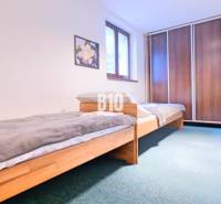 A bedroom in a three-room apartment with two beds and a built-in wardrobe.