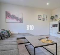 Living room with a comfortable couch and wall decorations in a two-room apartment.