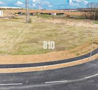 Building plot with reinforced infrastructure for housing, lighting. A field can be seen in the background.