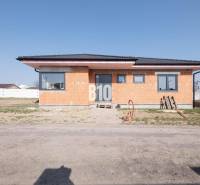 A family house in Veľký Lapáš with raw brick walls and a sloped roof.
